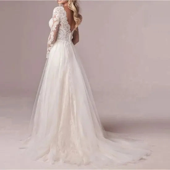 Robe de mariée bohème chic en dentelle avec décolleté en V et jupe fluide, portée par un mannequin pour une ambiance romantique.