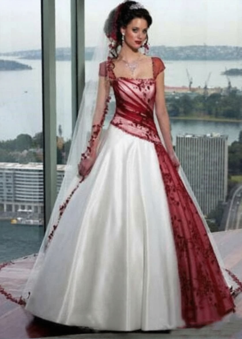 Robe de mariée rouge et blanche de la marque Robe de Mariée Paris, élégante, avec détails floraux et tissu soyeux.