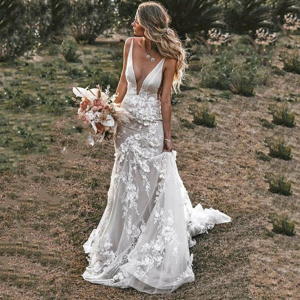 Robe de mariée bohème chic fluide, élégante, avec des détails légers et fluides, portée par une mariée lors d’un mariage en plein air.