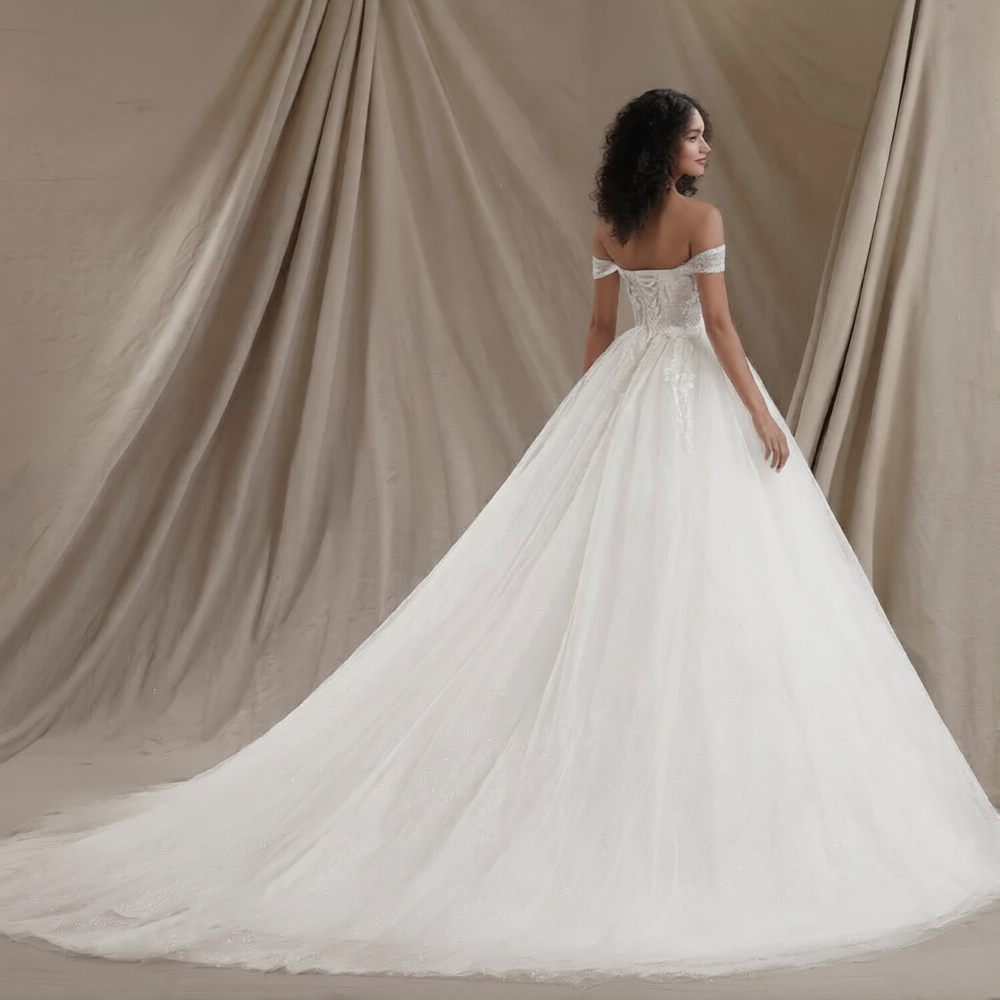 Robe de mariée princesse volumineuse de la marque Robe de Mariée Paris, détail de la jupe et du bustier en satin blanc.